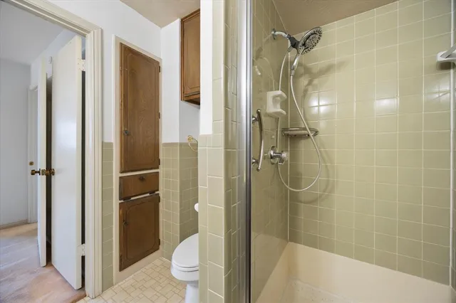 a bathroom with a toilet sink and shower