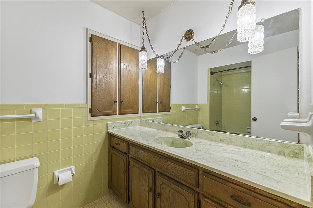2733 Biloxi Lane Mesquite, TX 75150 - Photo 21 of 28 a bathroom with a granite countertop sink a toilet and mirror
