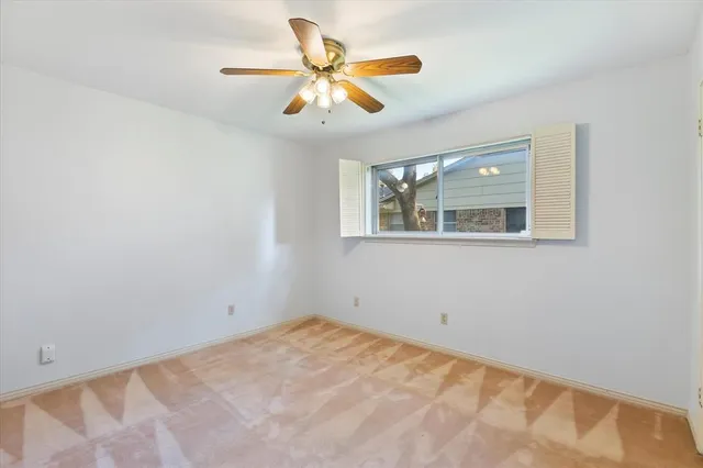 a view of a house with a yard and trees