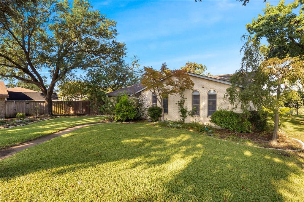 2733 Biloxi Lane Mesquite, TX 75150 - Photo 3 of 28 a view of a white house with a big yard and large trees