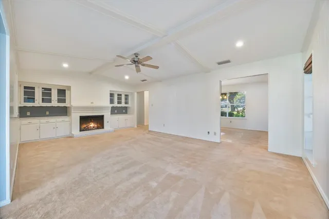 a view of an empty room with a fireplace