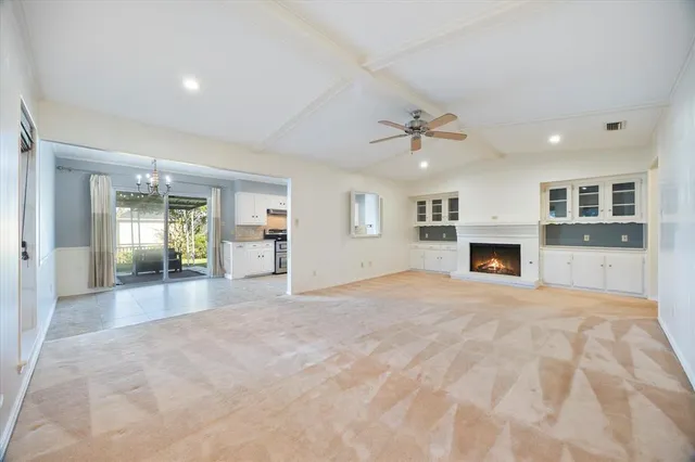 a view of an empty room with a fireplace