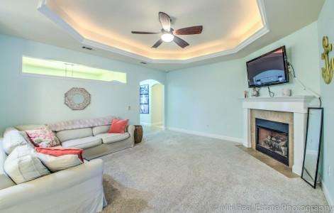 674 Red Fern Road Crestview, FL 32536 - Photo 8 of 23 a living room with furniture a flat screen tv and a fireplace