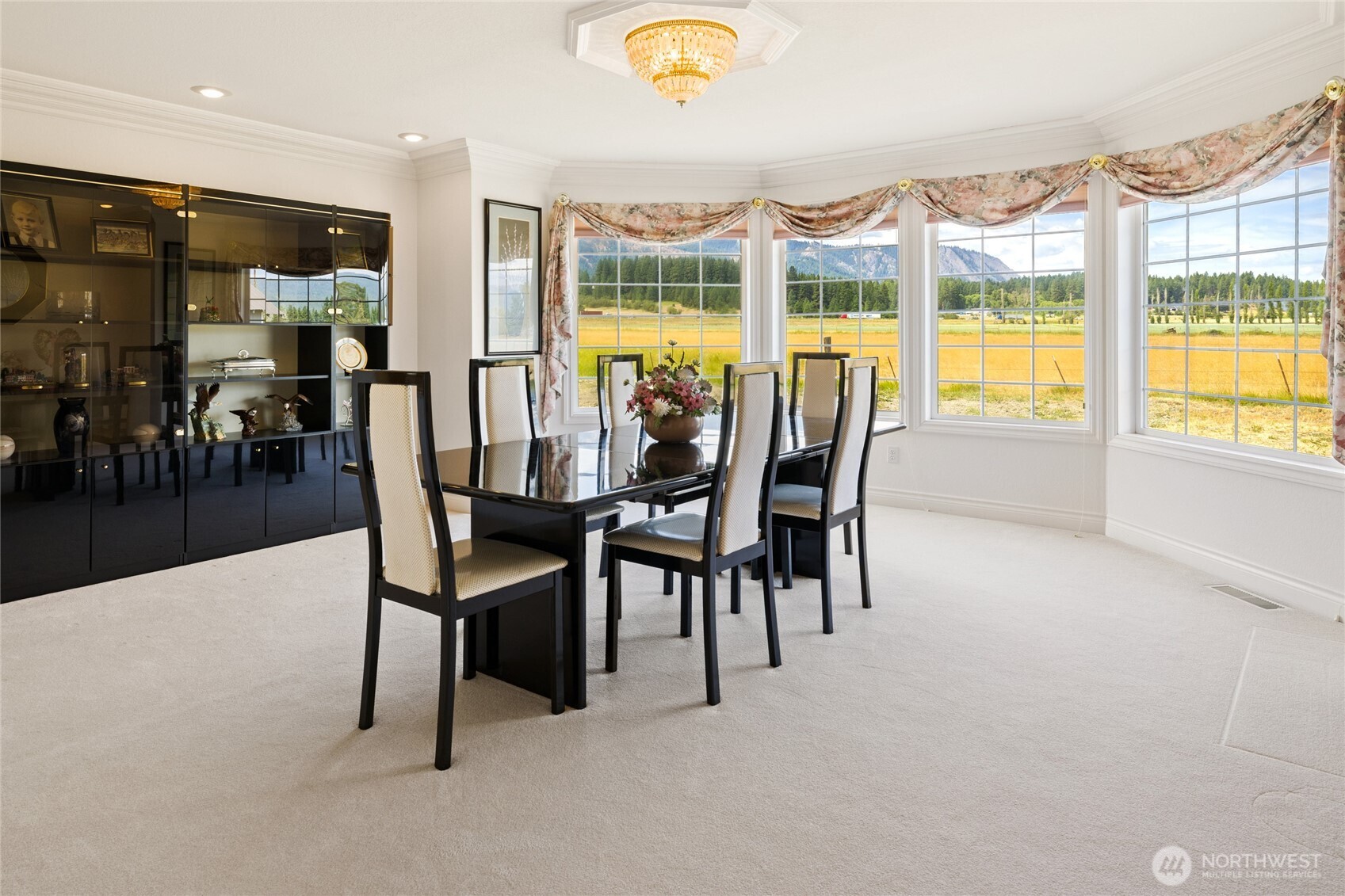 6280 Lower Peoh Point Road Cle Elum, WA 98922 - Photo 11 of 38 a dining room with furniture a chandelier and a flat screen tv