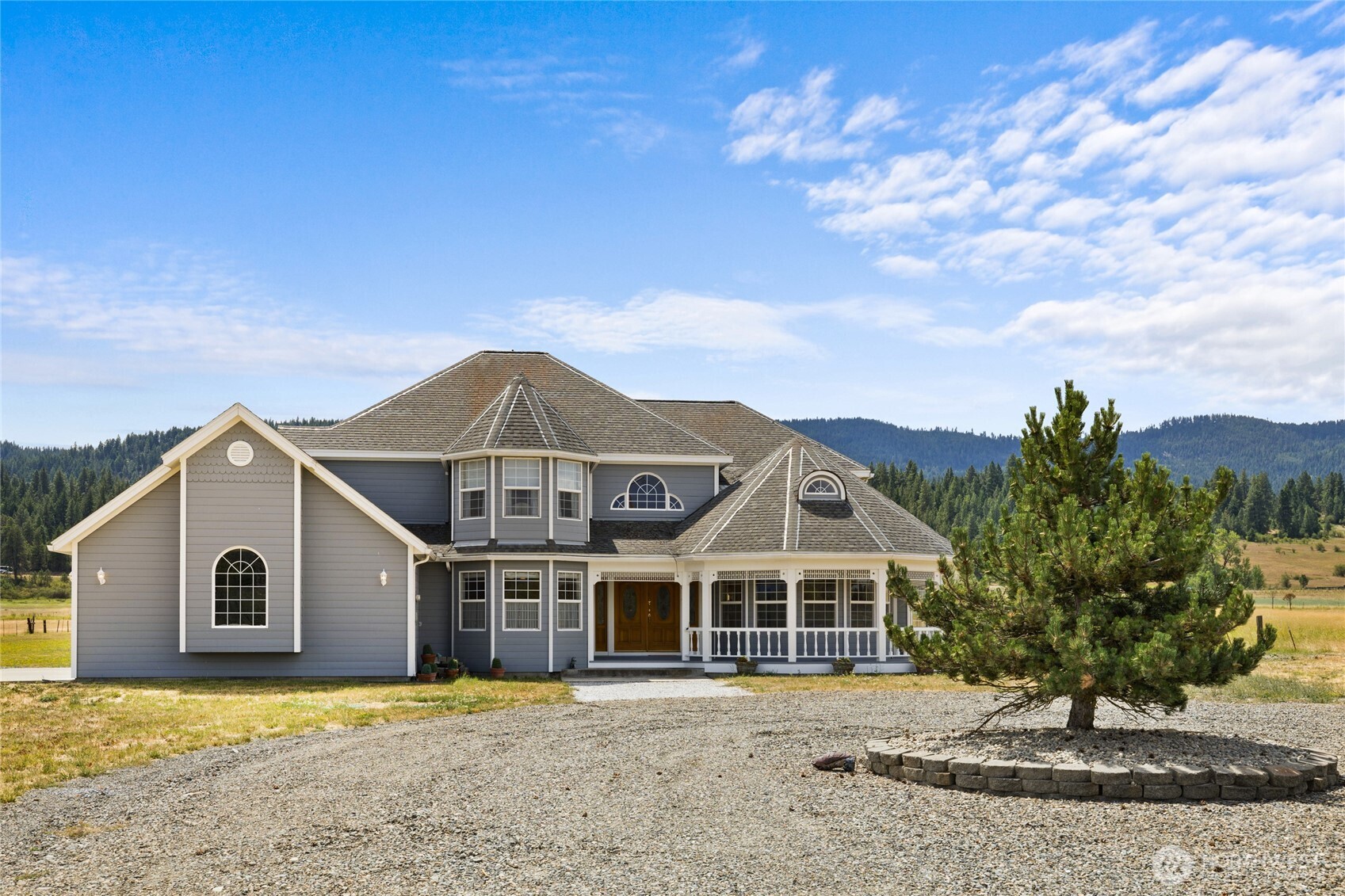 6280 Lower Peoh Point Road Cle Elum, WA 98922 - Photo 2 of 38 a front view of a house with a yard