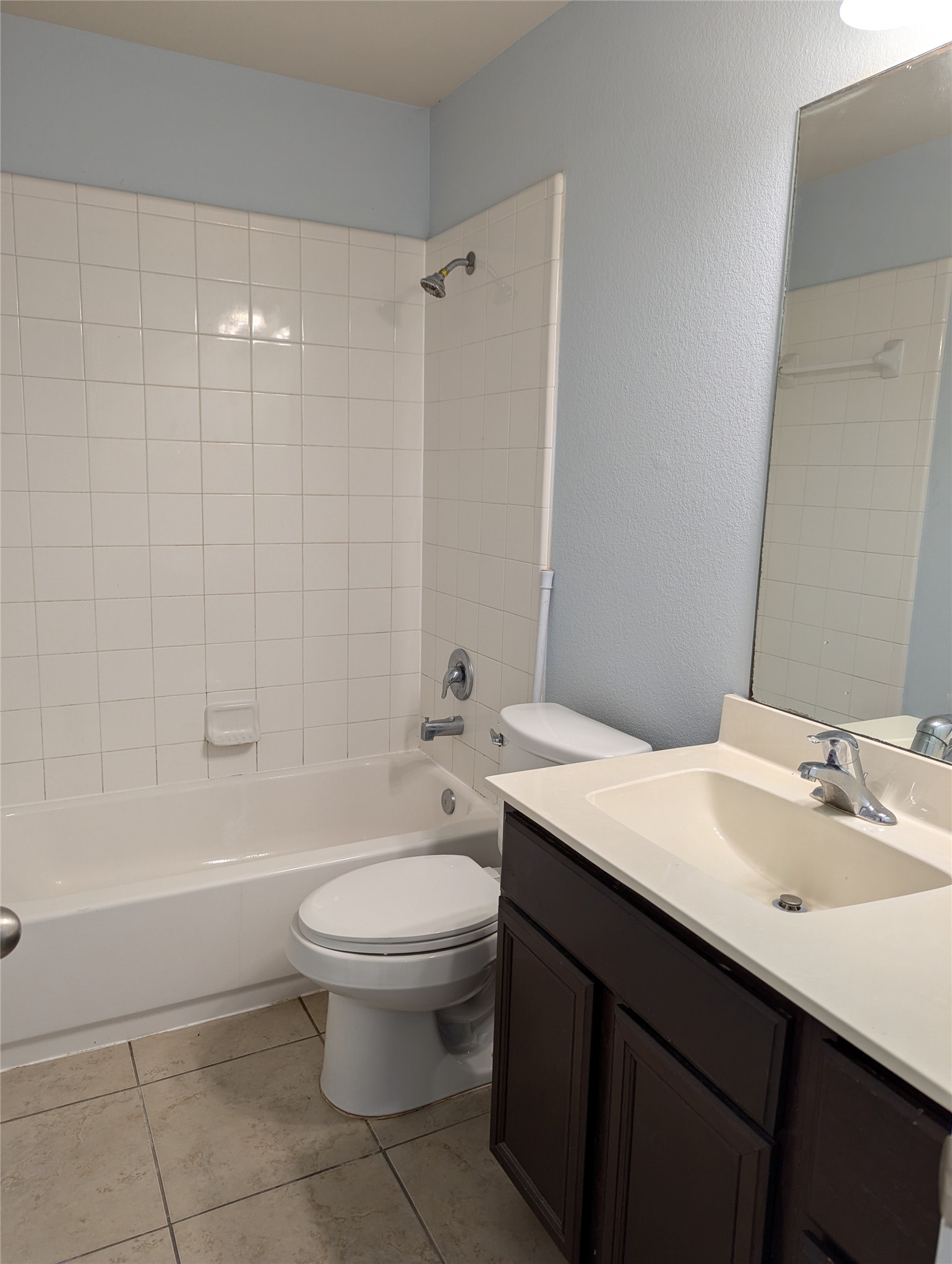 8041 Silent Deep Drive Rosenberg, TX 77469 - Photo 21 of 24 Charming Guest Bathroom: Featuring a pristine bathtub, modern fixtures, and a sleek vanity set against a serene blue backdrop.