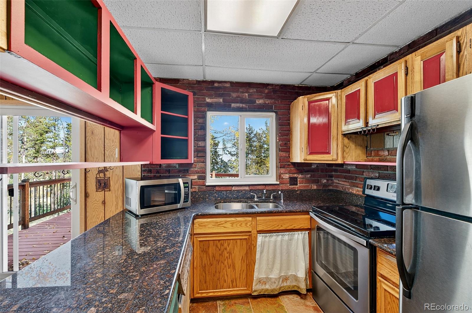 20341 Maxwell Drive Morrison, CO 80465 - Photo 14 of 47 a kitchen with stainless steel appliances granite countertop a refrigerator a sink and a stove