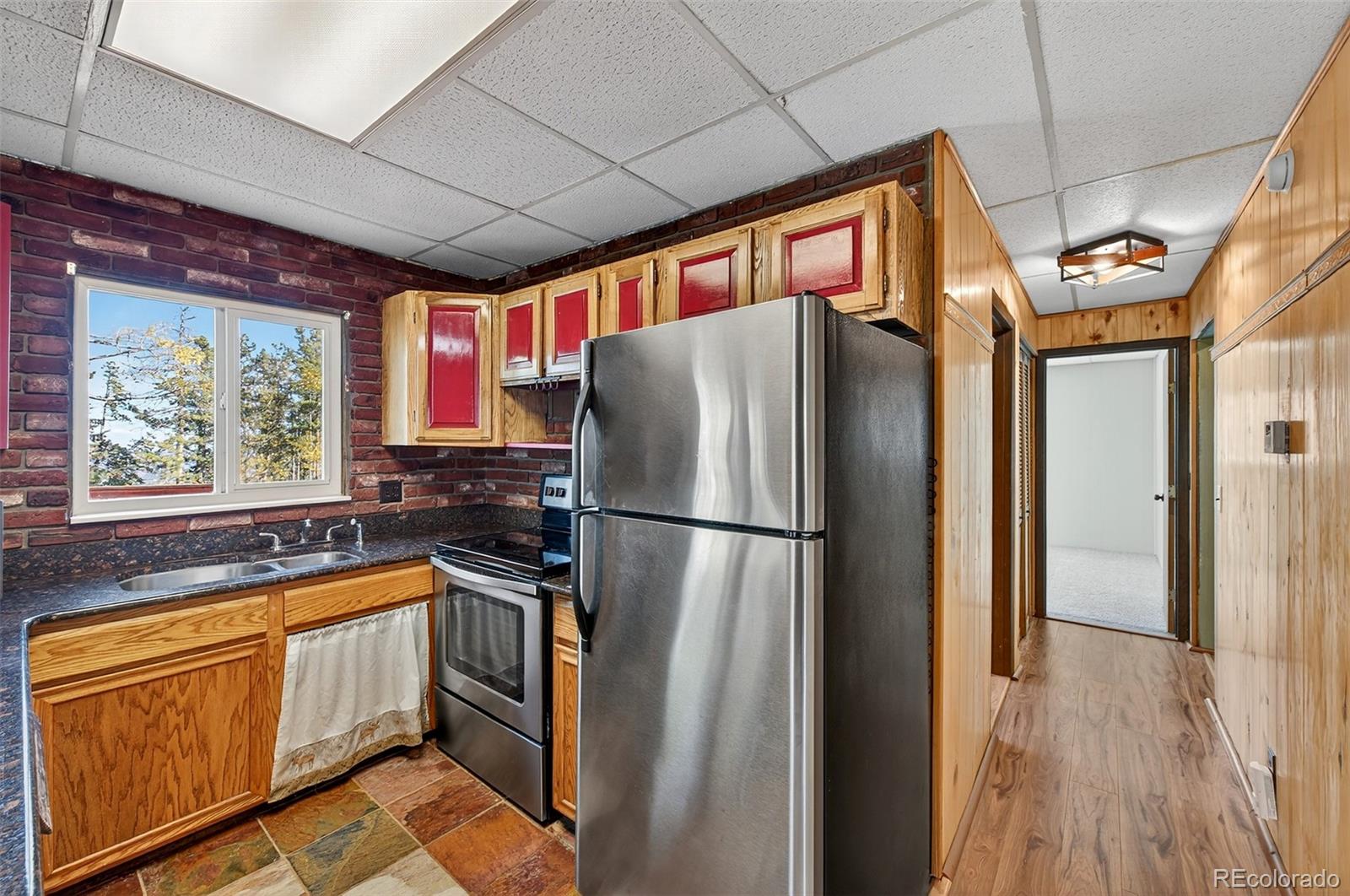20341 Maxwell Drive Morrison, CO 80465 - Photo 16 of 47 a kitchen with stainless steel appliances a refrigerator and a stove