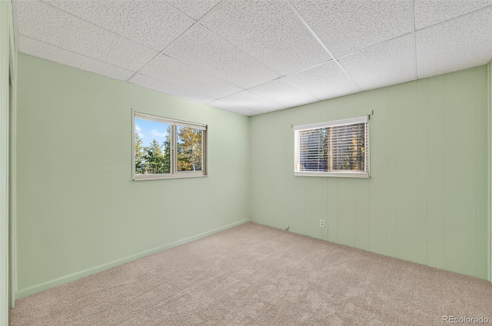 20341 Maxwell Drive Morrison, CO 80465 - Photo 18 of 47 an empty room with a painting on the wall