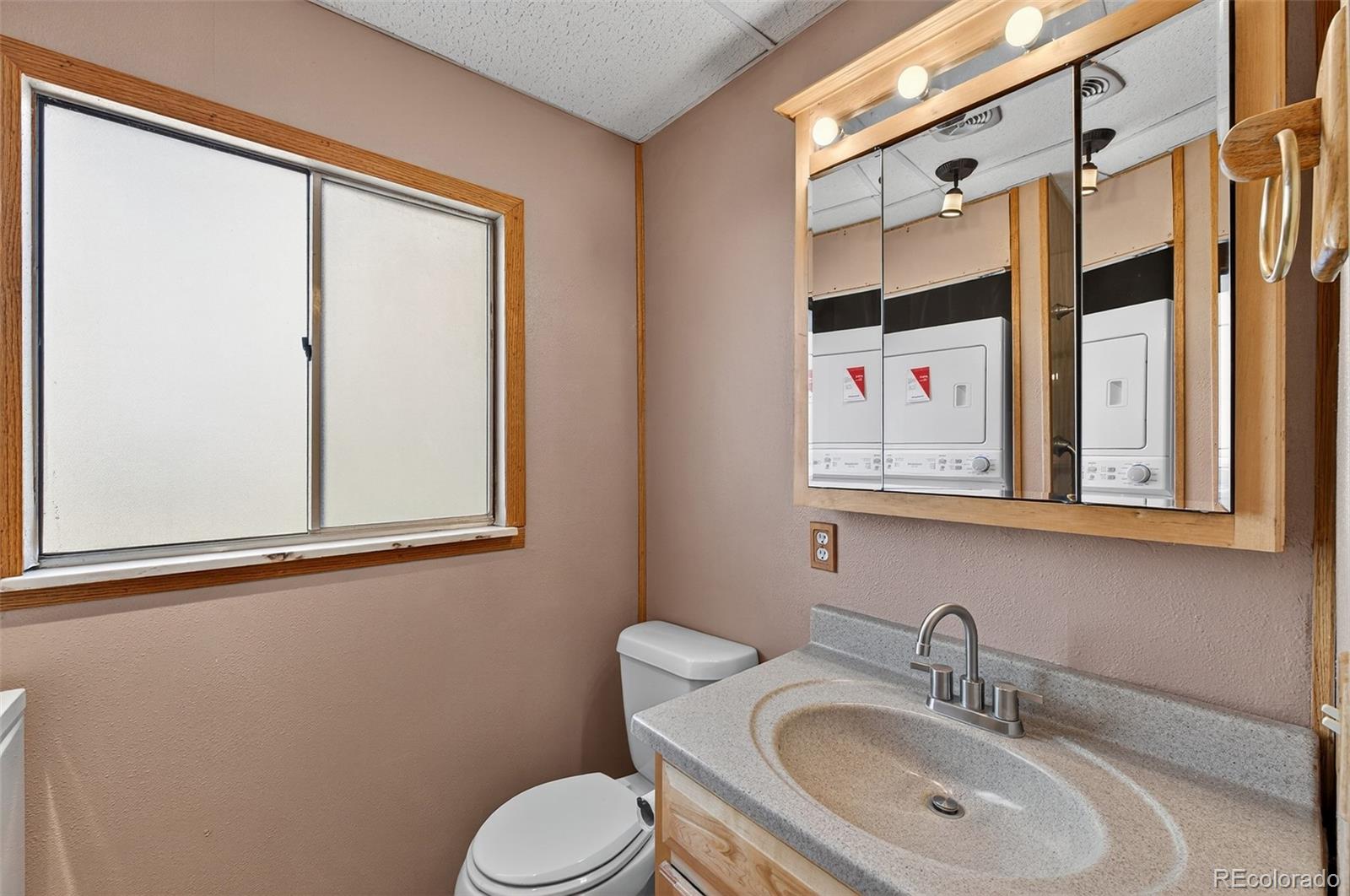 20341 Maxwell Drive Morrison, CO 80465 - Photo 23 of 47 a bathroom with a toilet sink and mirror