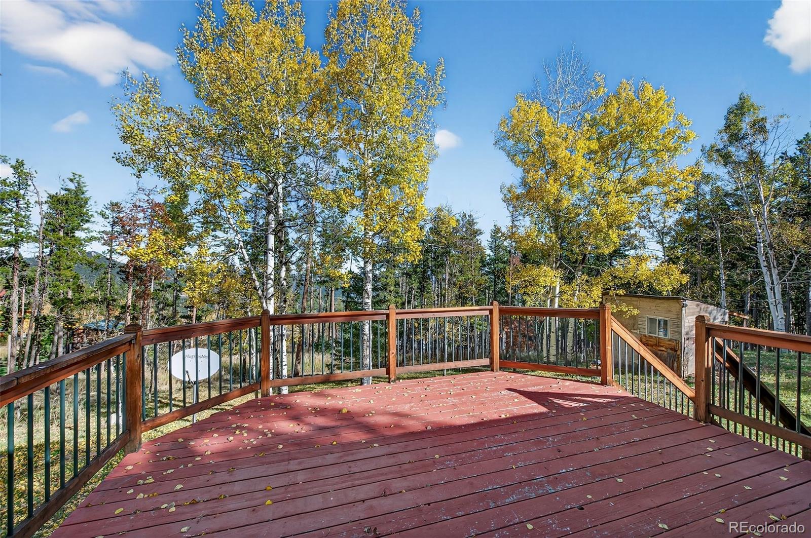 20341 Maxwell Drive Morrison, CO 80465 - Photo 24 of 47 a balcony with wooden floor and fence