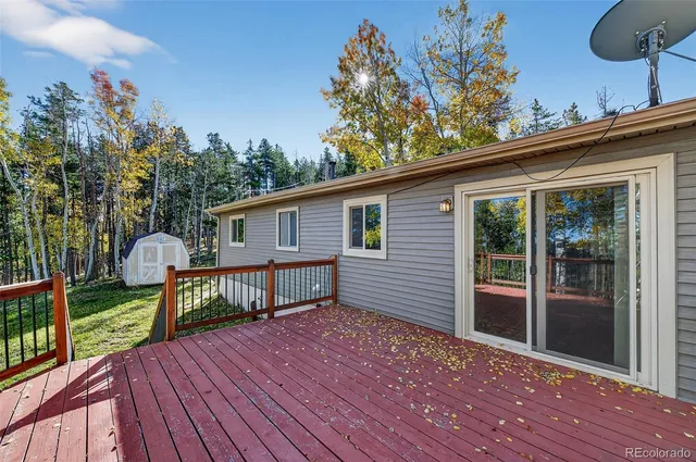 a view of balcony with wooden floor and fence