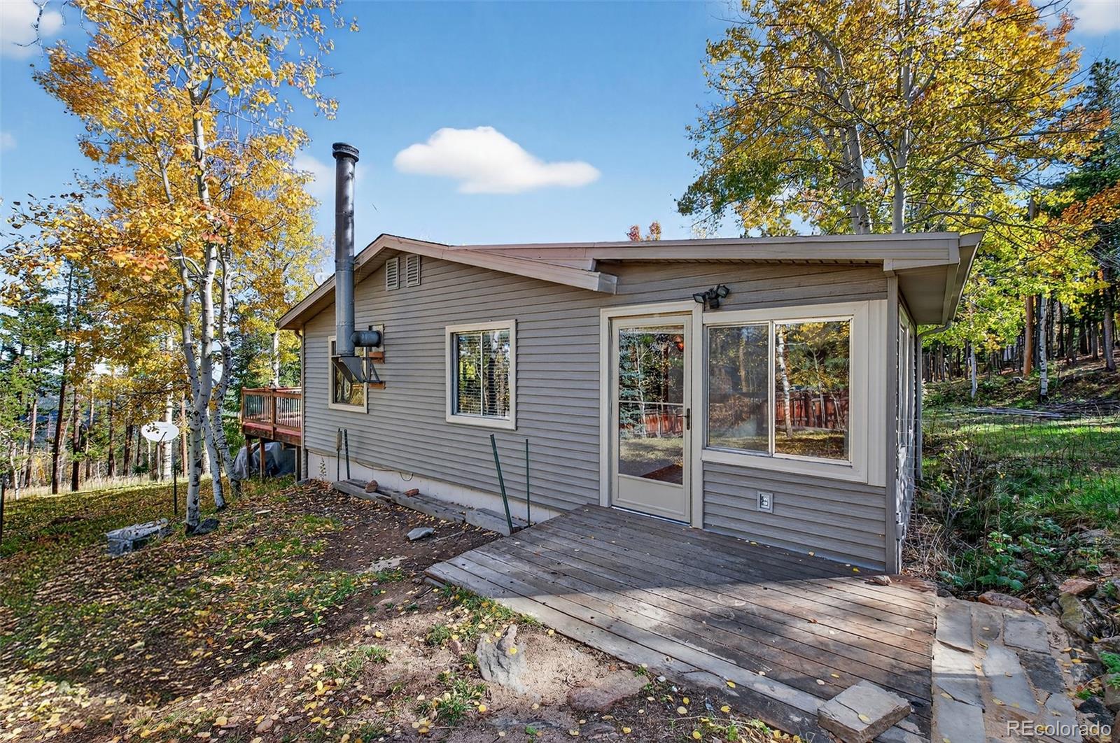 20341 Maxwell Drive Morrison, CO 80465 - Photo 4 of 47 a front view of a house with garden