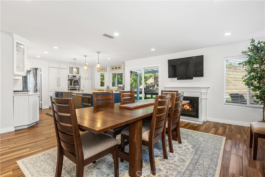 6059 Rio Valle Drive Bonsall, CA 92003 - Photo 21 of 46 Fireplace in family room currently used as dining space: Digitally altered fire in fire place