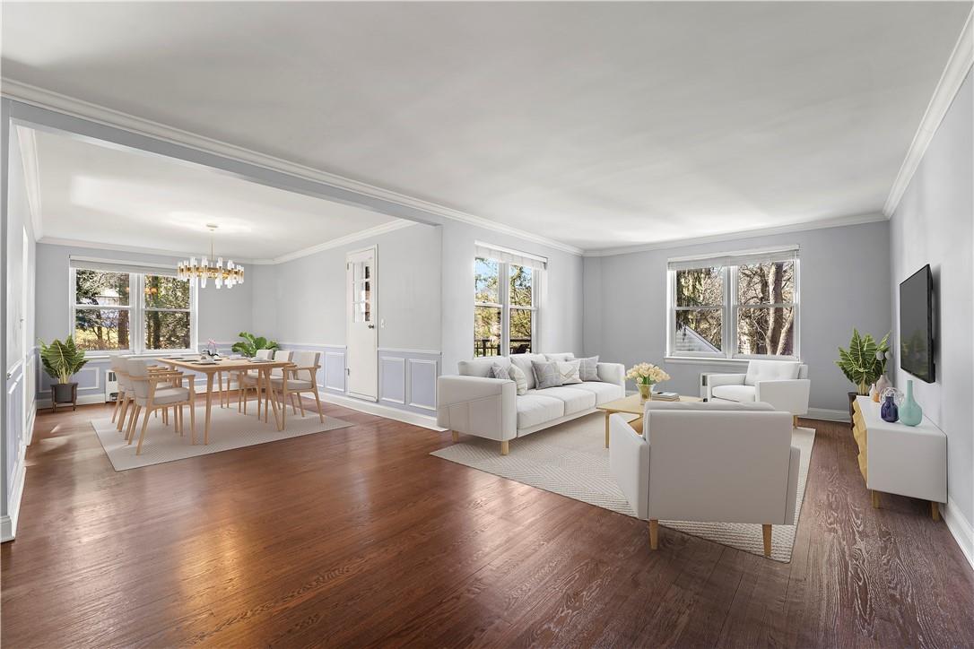 Welcome to this two-bedroom two-bath unit featuring hardwood floors, three exposures, terrace and deeded parking.  This photo is virtually stage.