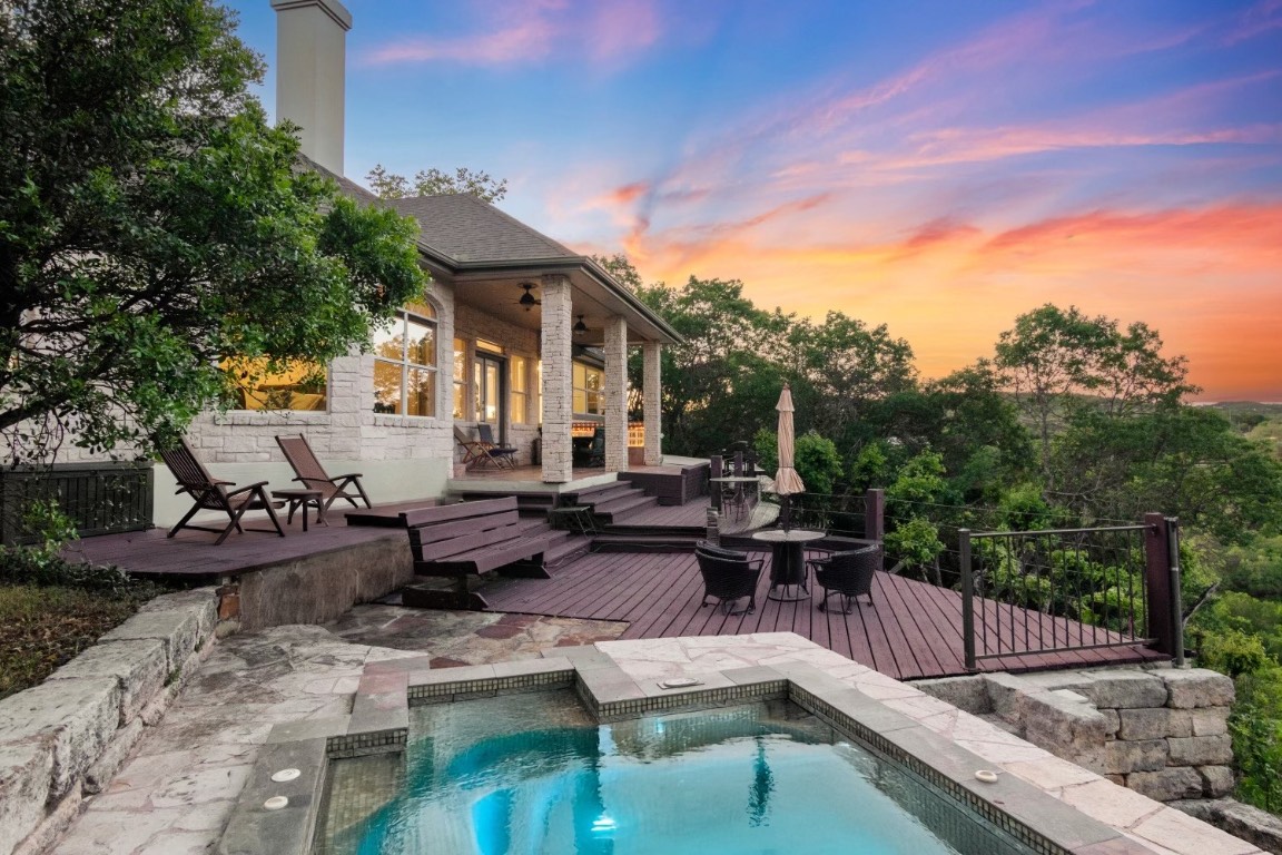 a view of a patio with couches table and chairs and potted plants