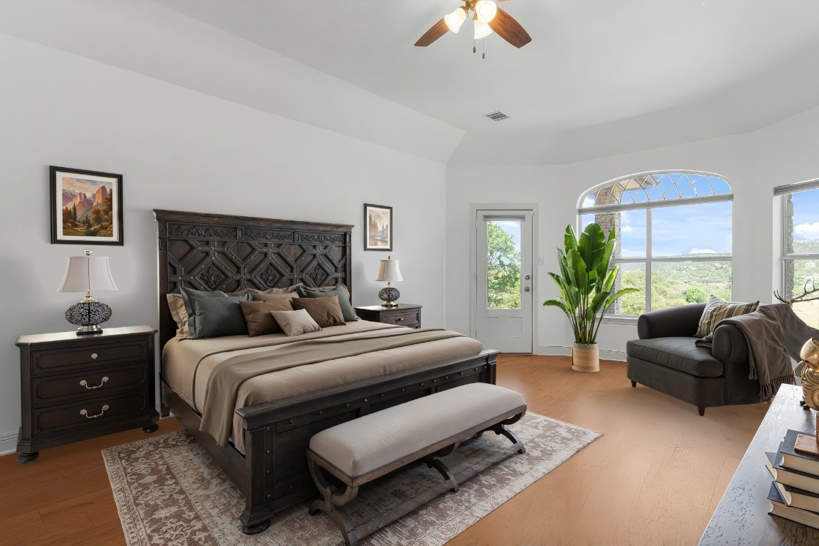 18408 West Rim Drive Jonestown, TX 78645 - Photo 17 of 30 a bedroom with a bed a couch and a chandelier