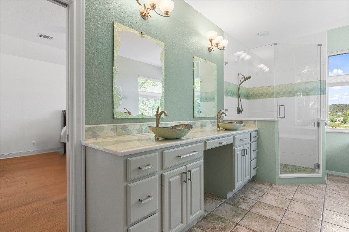 18408 West Rim Drive Jonestown, TX 78645 - Photo 18 of 30 a large bathroom with a double vanity sink and a mirror