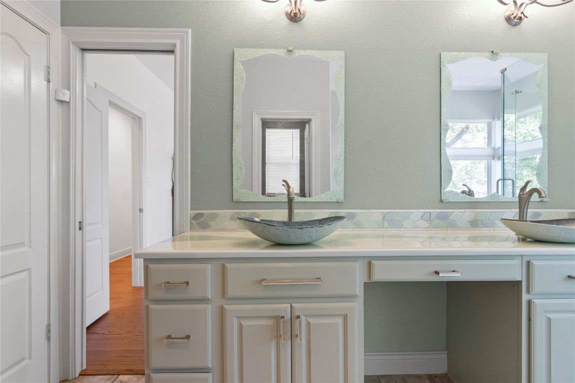 18408 West Rim Drive Jonestown, TX 78645 - Photo 19 of 30 a bathroom with a granite countertop sink and a mirror