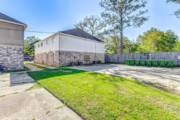 a view of a house with a yard and a patio