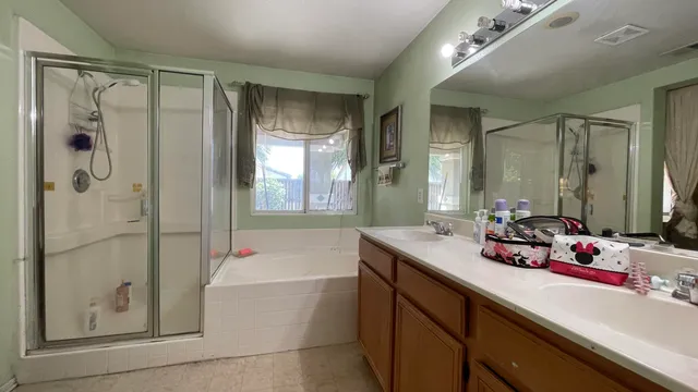 a bathroom with a tub sink and mirror