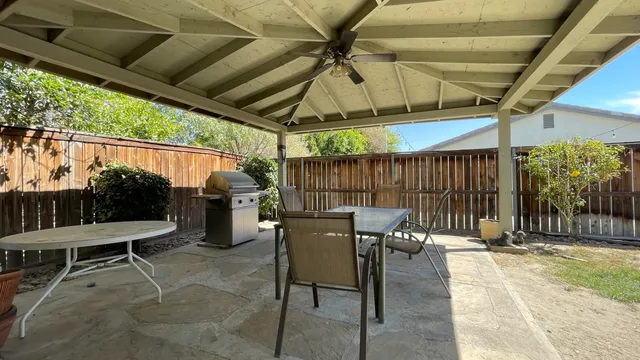 a view of a patio with a table and chairs