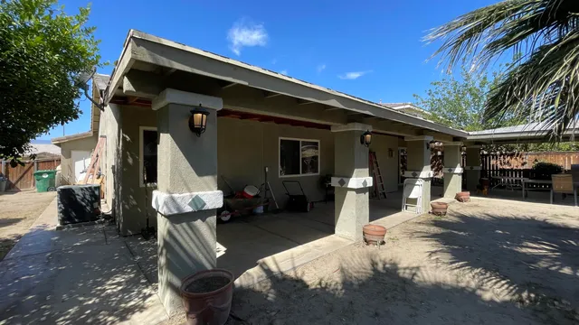 a front view of a house with outdoor seating