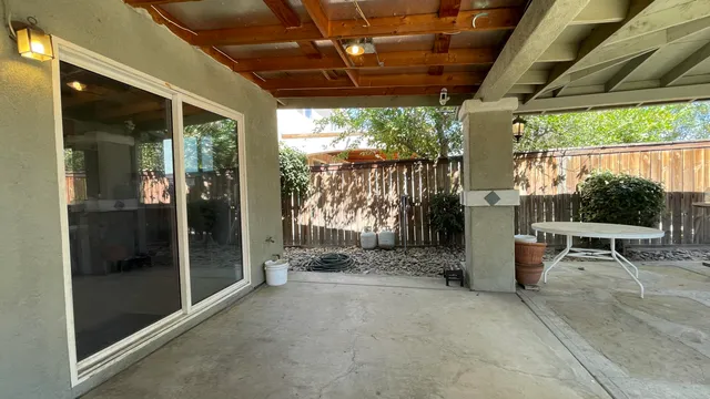 a view of a porch with furniture and a backyard