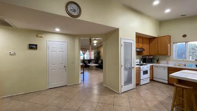 a kitchen with a refrigerator and a stove top oven