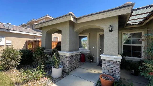 a front view of a house with outdoor seating
