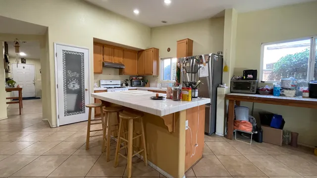 a kitchen with stainless steel appliances kitchen island granite countertop a sink and cabinets