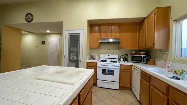a kitchen with a sink a stove and cabinets