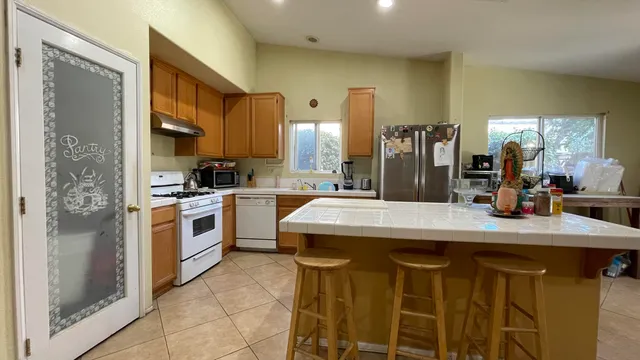 a kitchen with a stove a sink cabinets and a counter top space