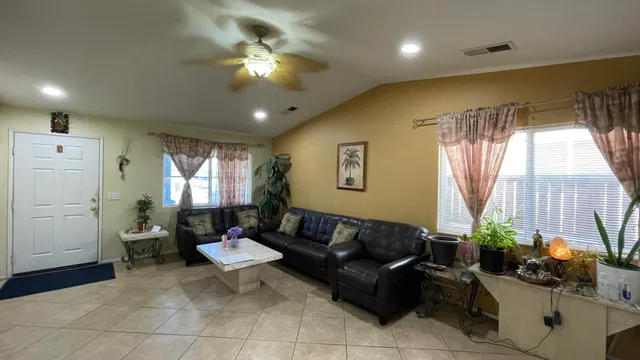 a living room with furniture and a large window