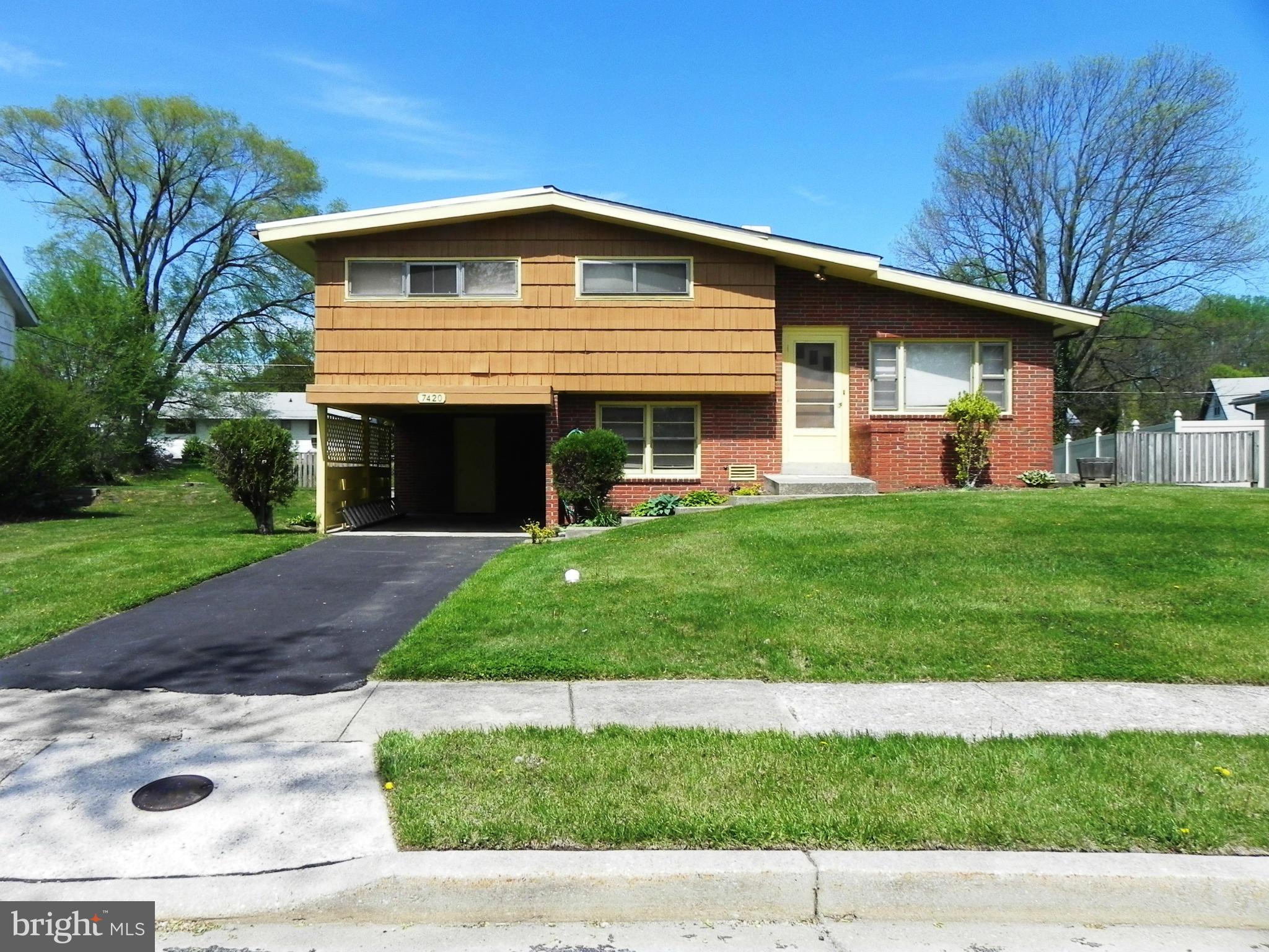 7420 Monita Road Baltimore, MD 21208 - Photo 1 of 24 a front view of a house with a yard and garage