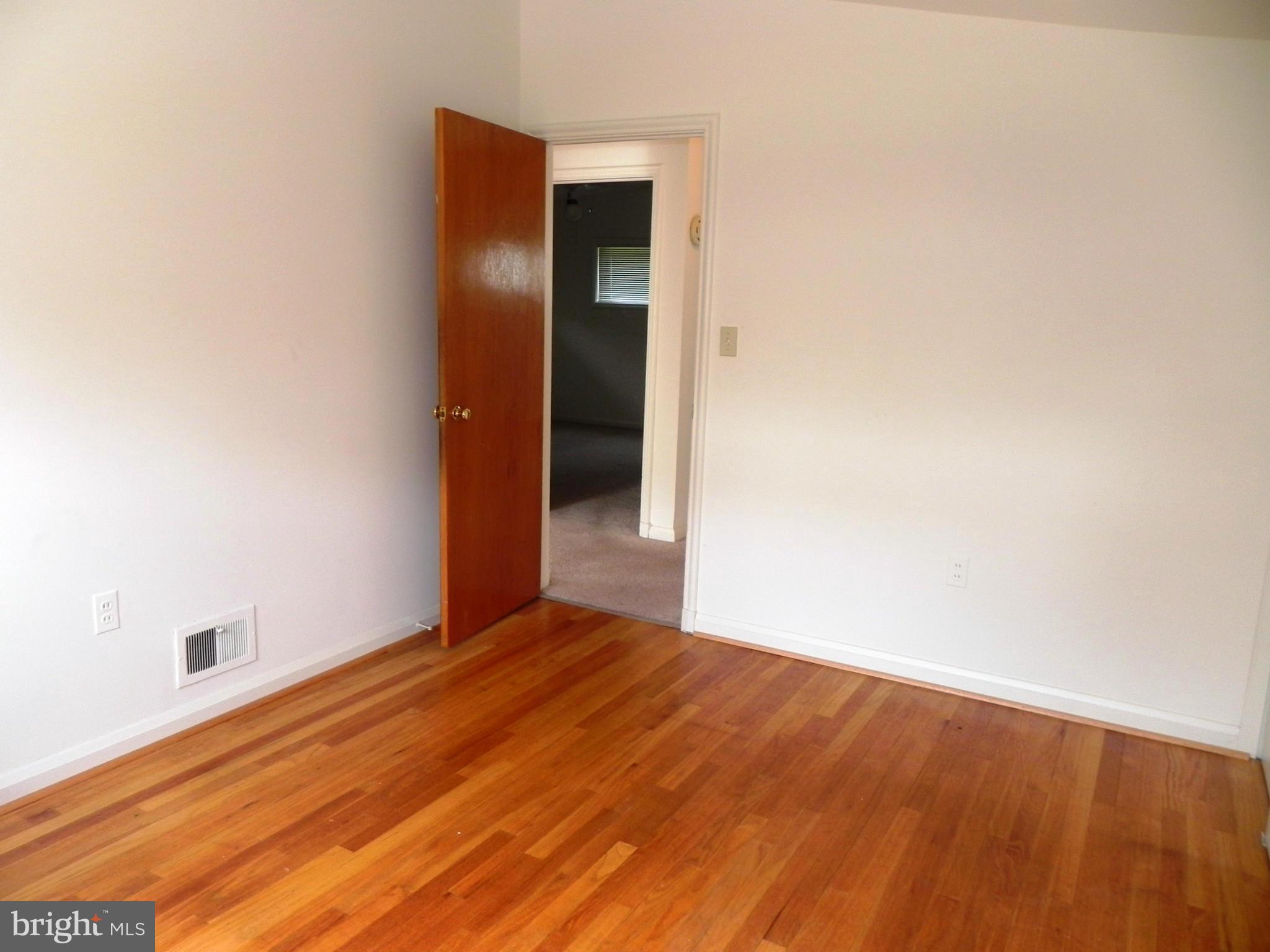 7420 Monita Road Baltimore, MD 21208 - Photo 13 of 24 a view of an empty room with wooden floor