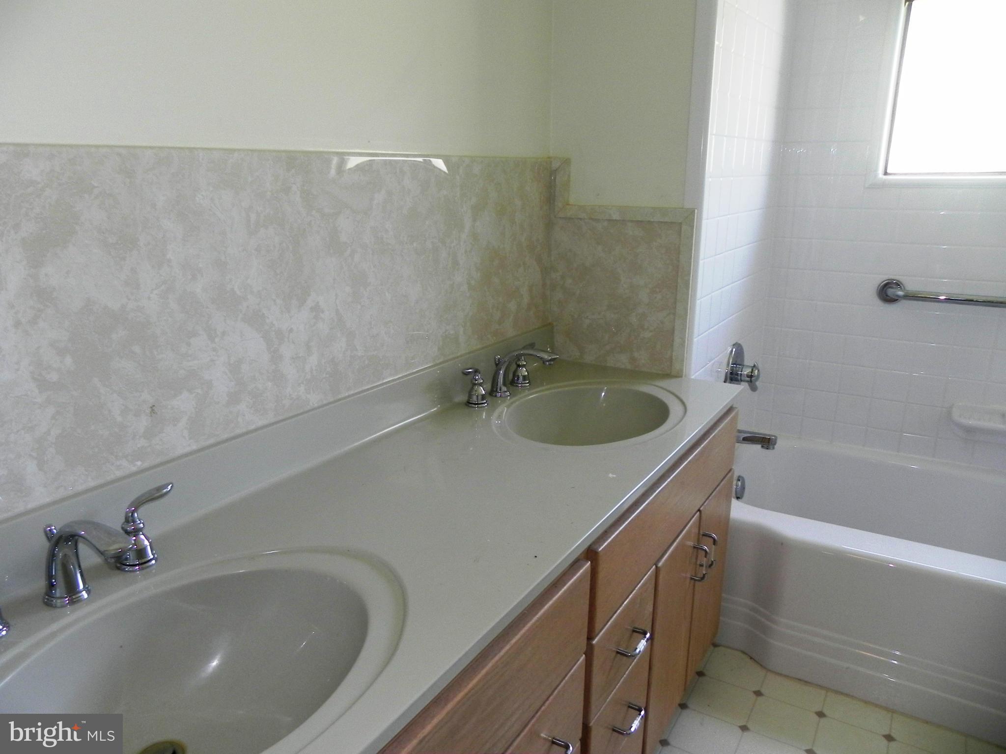 7420 Monita Road Baltimore, MD 21208 - Photo 17 of 24 a bathroom with a sink and a bathtub