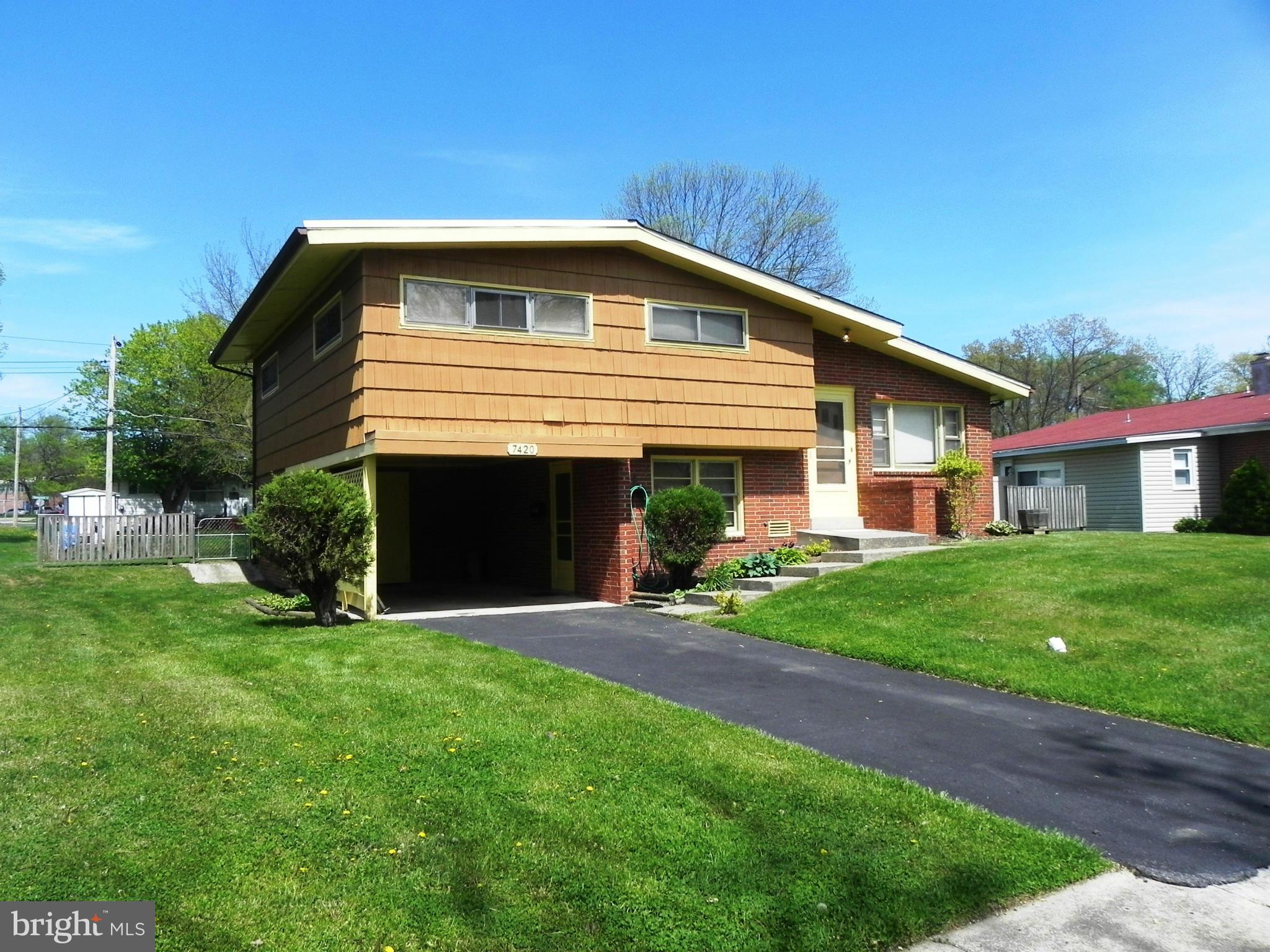 7420 Monita Road Baltimore, MD 21208 - Photo 3 of 24 a front view of a house with a garden and yard