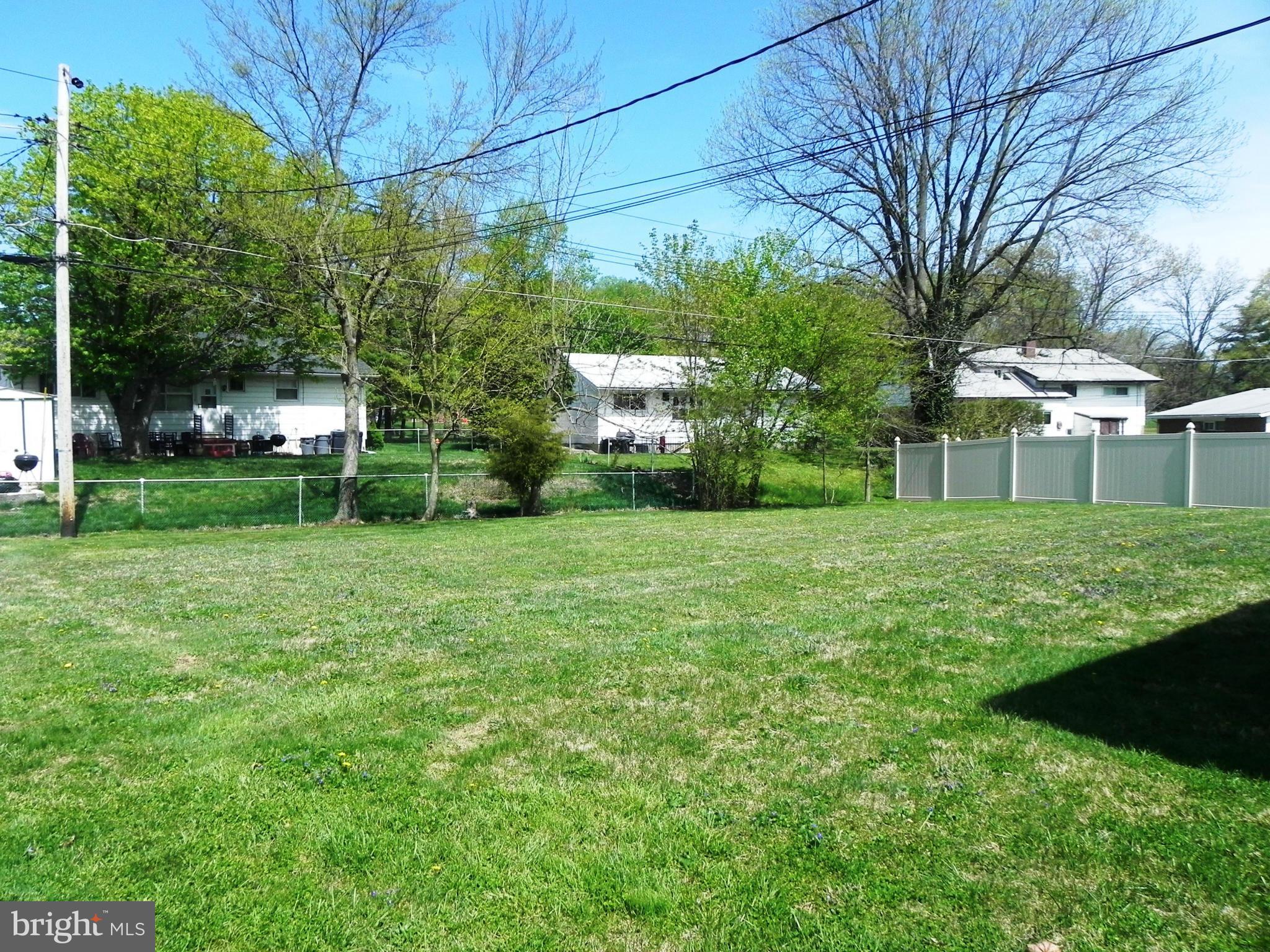 7420 Monita Road Baltimore, MD 21208 - Photo 23 of 24 a view of a house with a big yard and large trees