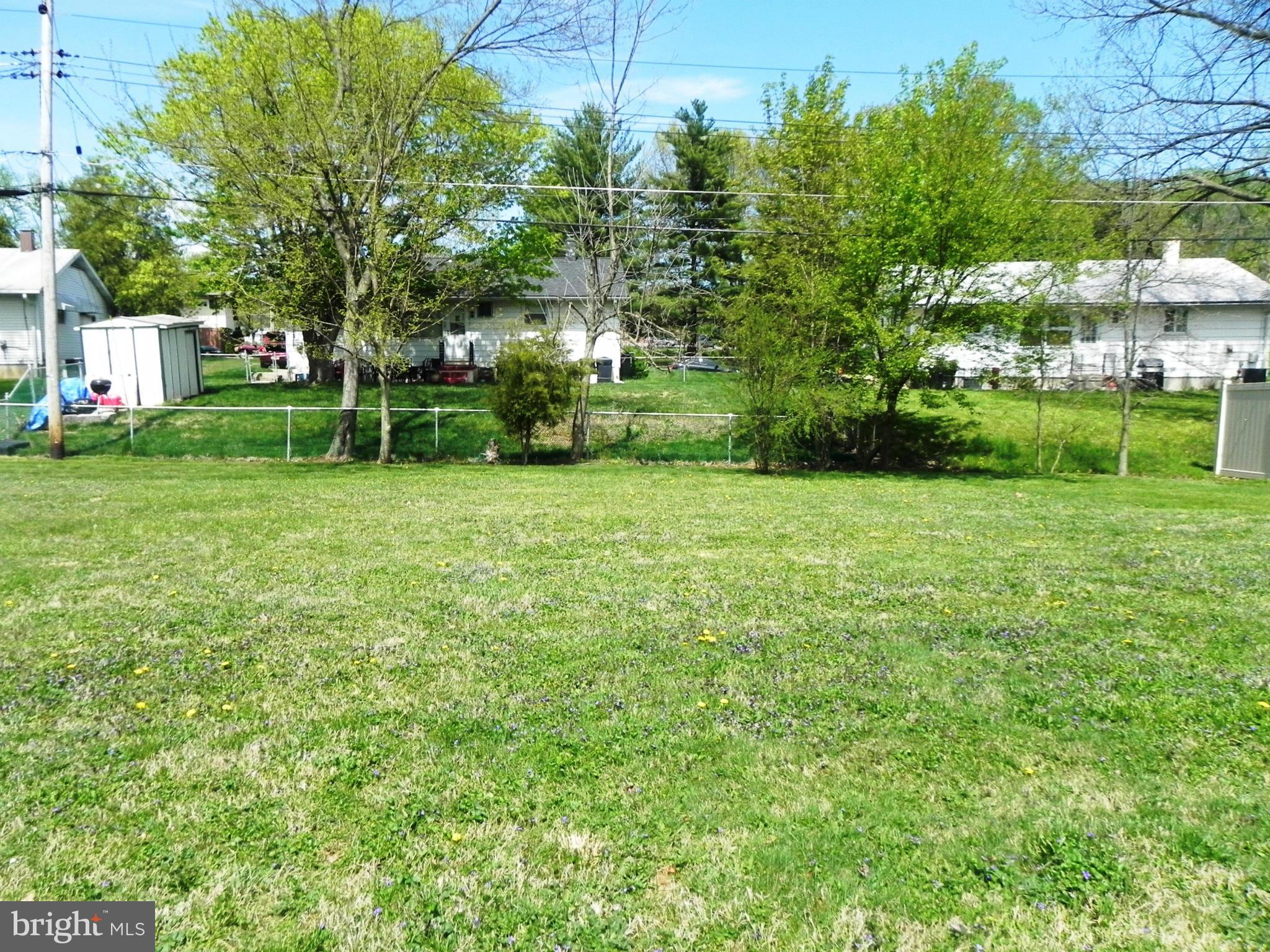 7420 Monita Road Baltimore, MD 21208 - Photo 24 of 24 a view of a house with a big yard and large trees