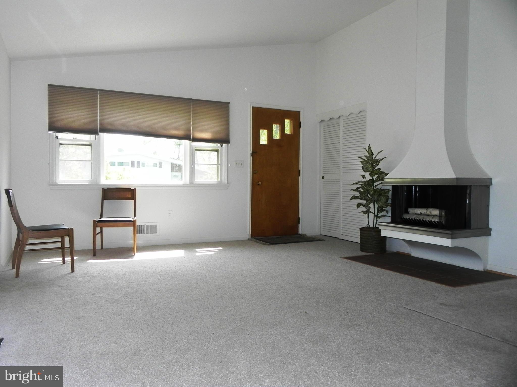 7420 Monita Road Baltimore, MD 21208 - Photo 4 of 24 a living room with furniture and a fireplace