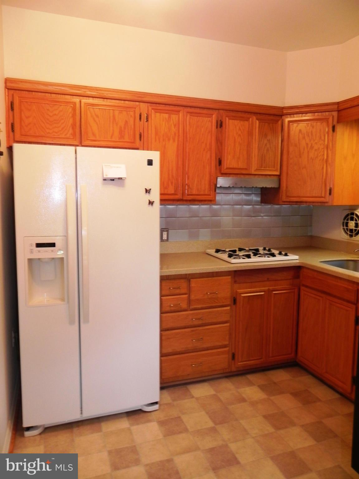 7420 Monita Road Baltimore, MD 21208 - Photo 10 of 24 a kitchen with stainless steel appliances granite countertop a refrigerator and a sink