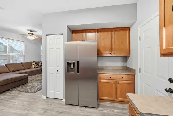 a kitchen with a refrigerator and cabinets