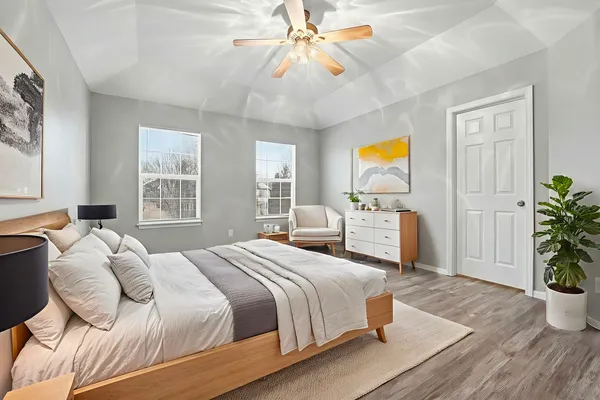 a bedroom with a bed and a potted plant