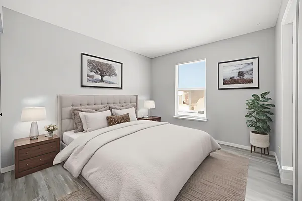 a bedroom with a bed and a painting on the wall