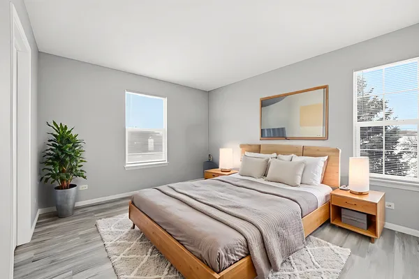 a bedroom with a bed and wooden floor