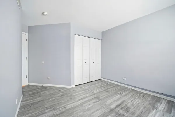 a view of room with wooden floor