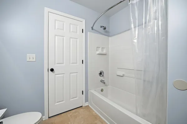 a bathroom with a bathtub and a toilet