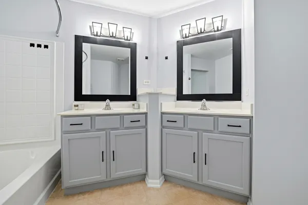 a bathroom with 2 sink and a mirror