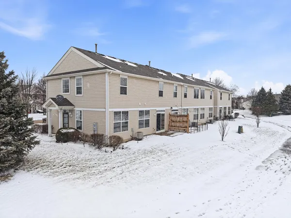 a view of a house with snow on the road